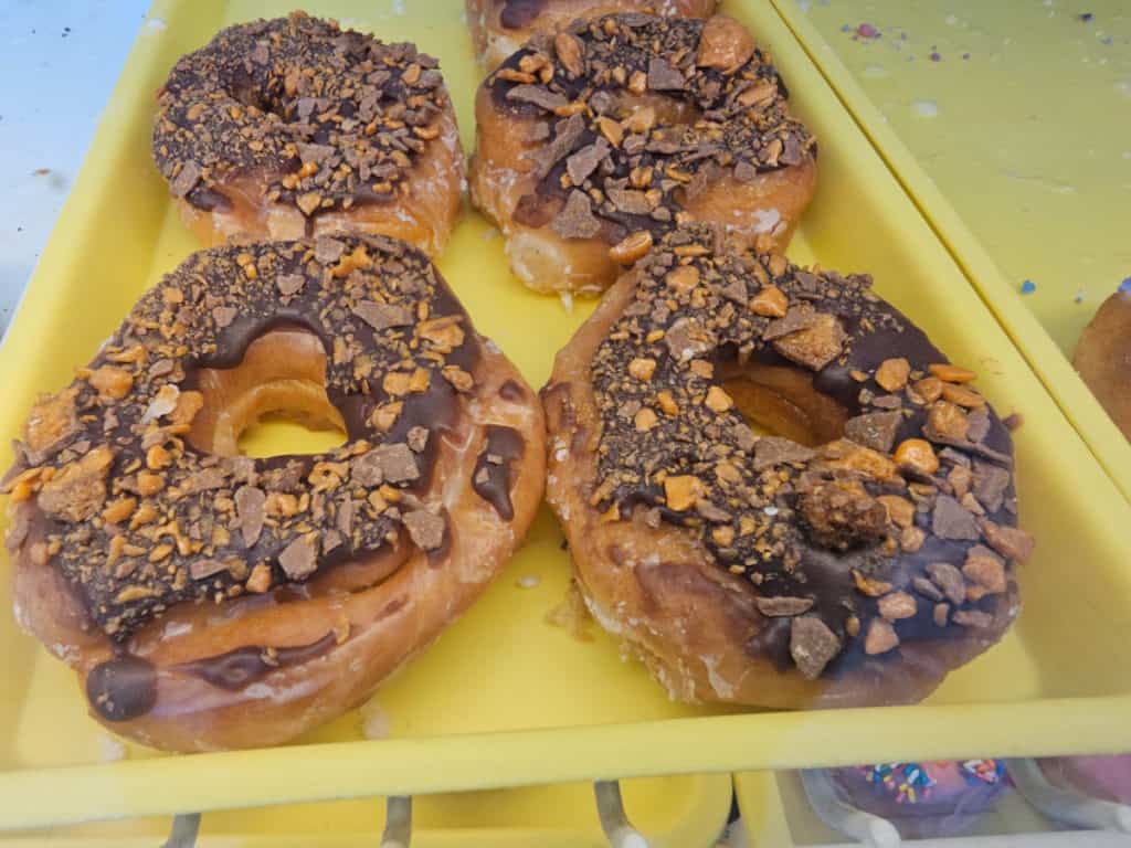 Butterfinger doughnuts on a yellow tray