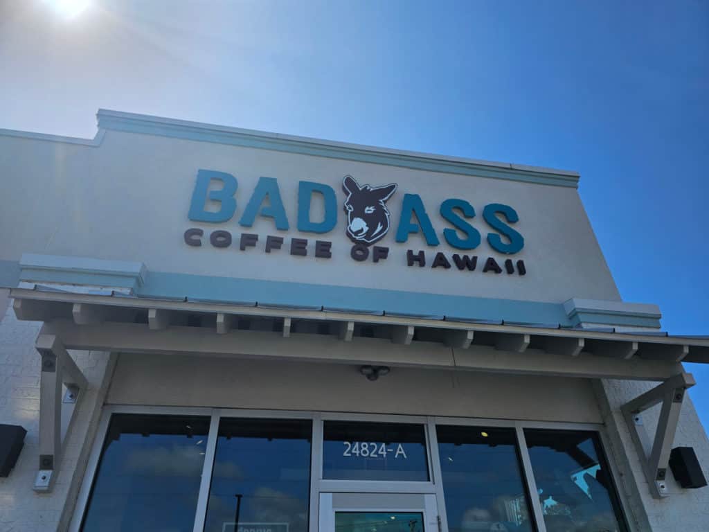 Exterior of Bad Ass Coffee of Hawaii with donkey head and glass door