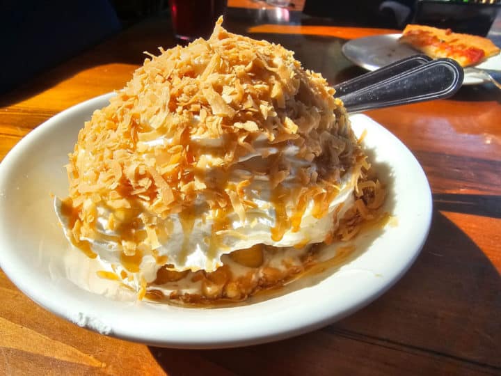 toasted coconut on whipped cream in a white bowl