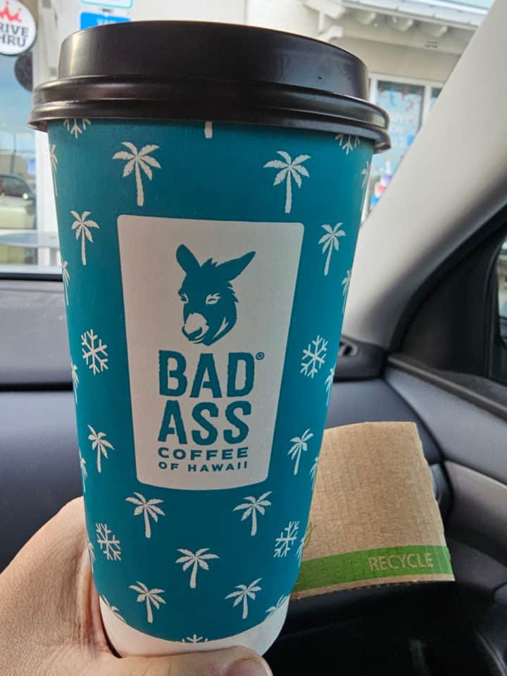 Blue cup with palm trees and snowflakes along with the Bad Ass Coffee of Hawaii logo