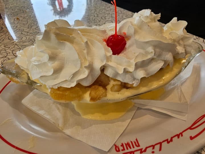 caramel apple sundae on a Sunliner Diner plate with whipped cream and a cherry