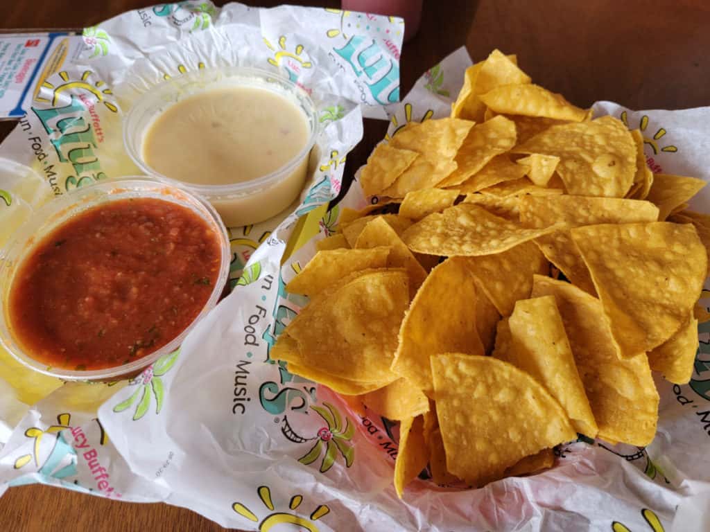 Chips, salsa and queso in baskets with LuLu's paper