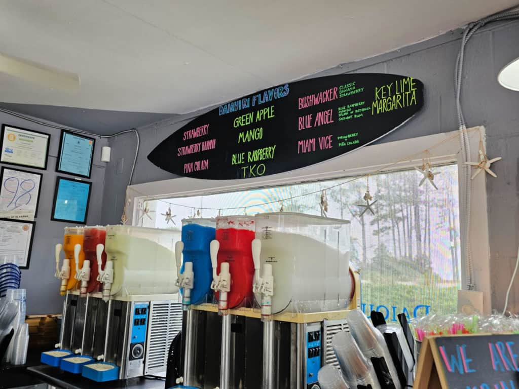 Daiquiri machines and flavors listed on a surfboard