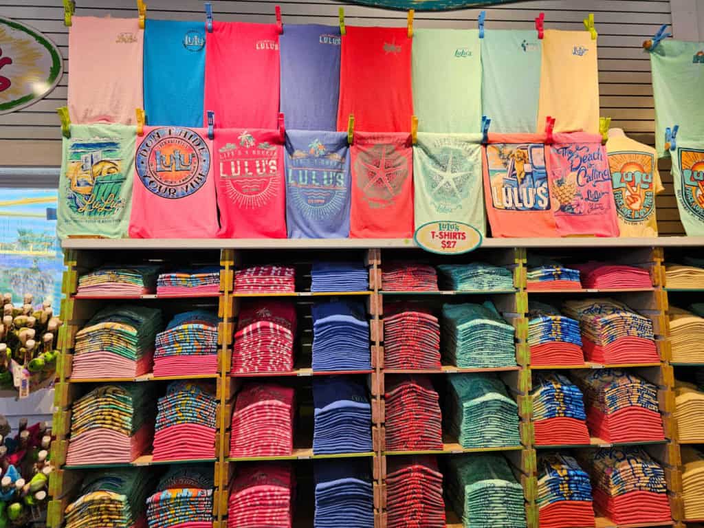 LuLu's Gulf Shores t-shirt display with folded shirts and hanging shirts