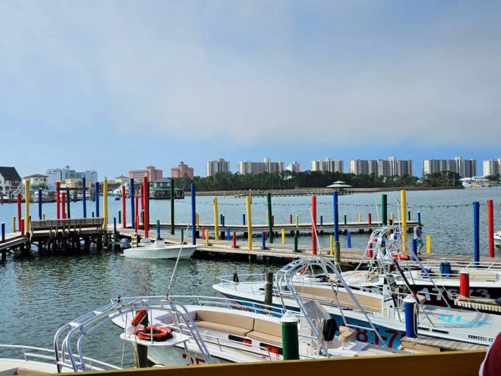 Boat marina with brightly colored posts and boats at Tacky Jacks Orange Beach