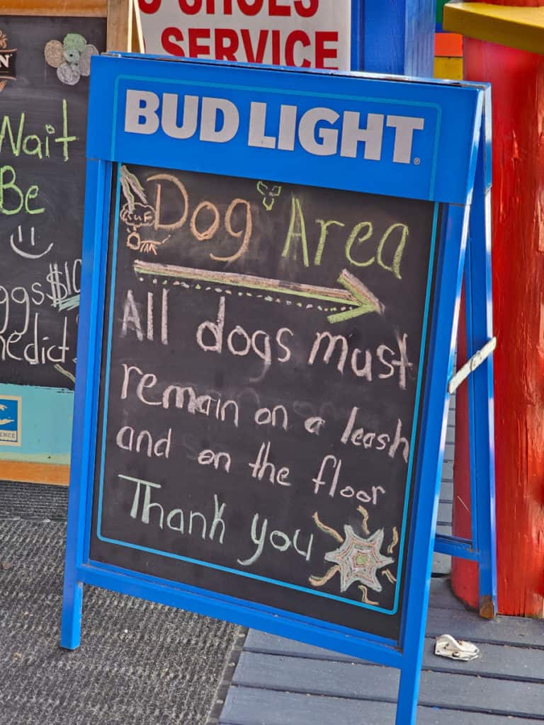 Dog area sign pointing to seating area at Tacky Jacks Orange Beach