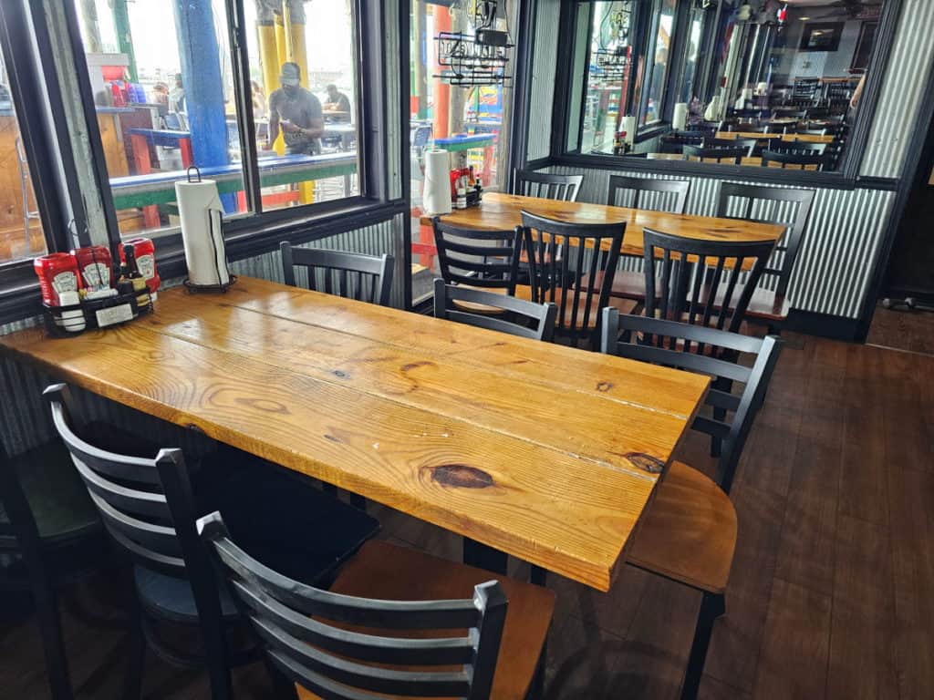 Wooden table and chairs indoors at Tacky Jacks Orange Beach