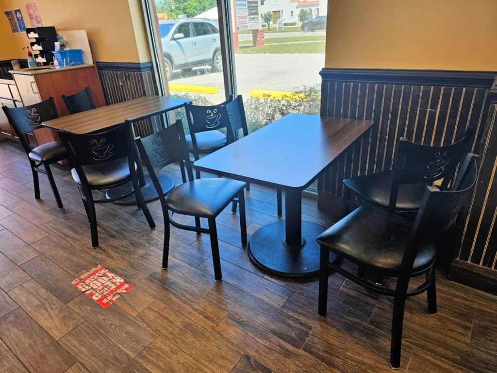 interior seating with table and chairs at Lickin Good Donuts