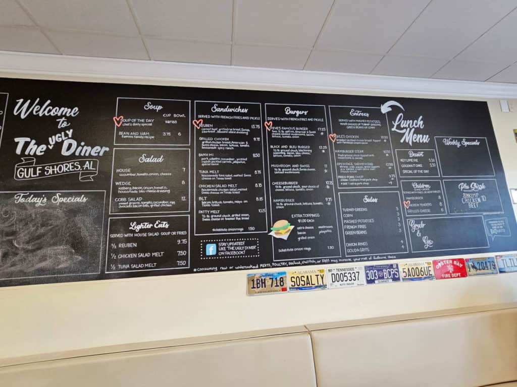 Lunch menu at The Ugly Diner printed on a black chalkboard wall