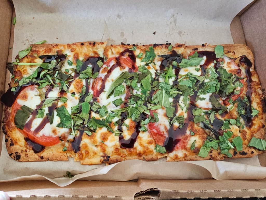 margherita pizza in a pizza box from Island Wing Company