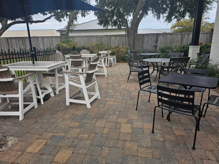 outdoor tables and chairs on a brick patio