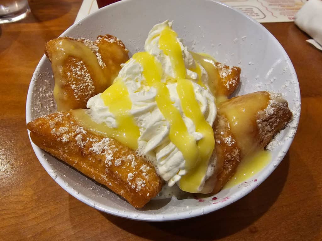 Seasonal Beignets with lemon curd and whipped cream