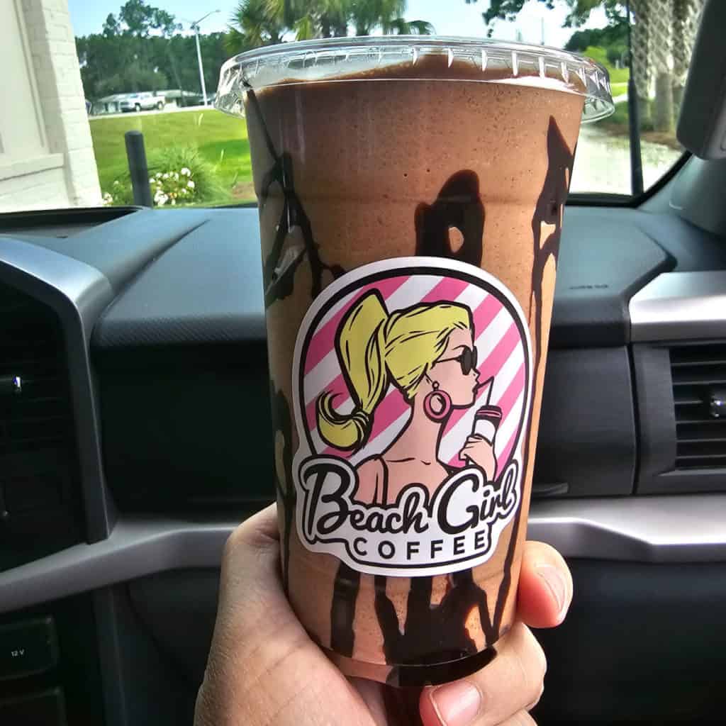 Beach Girl Coffee sticker on a chocolate coffee drink in a plastic glass