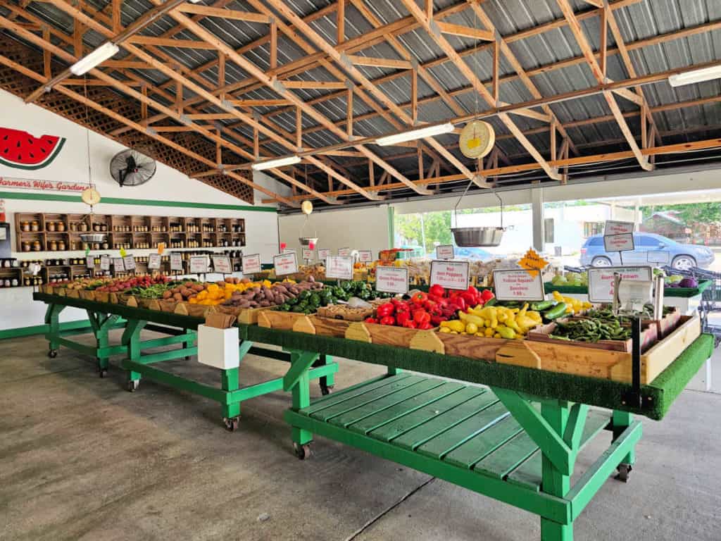 Fresh vegetables on green farm stand tables in Burris Farm Market