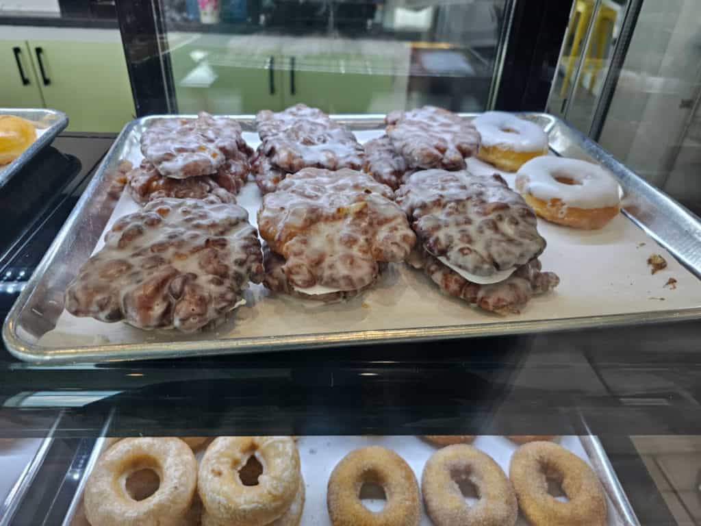 fritters and donuts on a parchment lined tray at Pete's Ice cream and Doughnuts