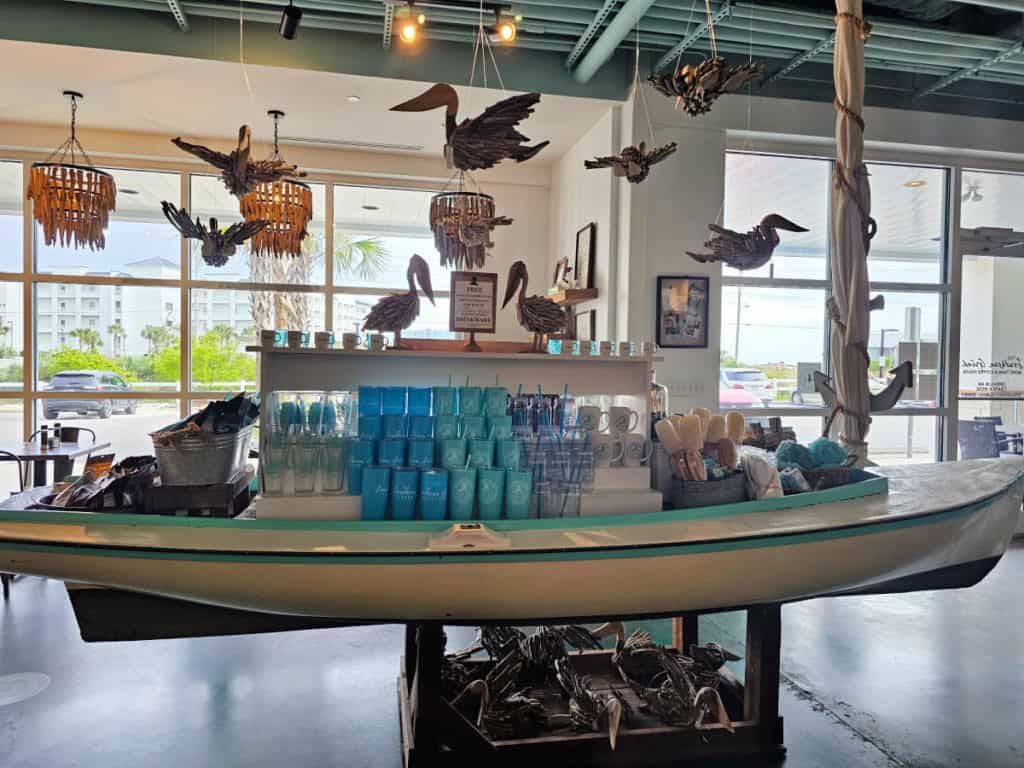 Boat gift shop display in Southern Grind Coffee Shop with hanging driftwood pelicans