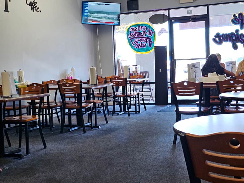 Indoor seating in Cafe Beignet Orange Beach with tables and chairs