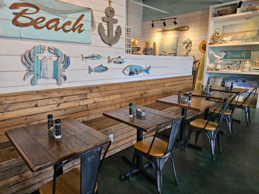 indoor seating with tables and bench seating by coastal decor in Southern Grind Coffee House