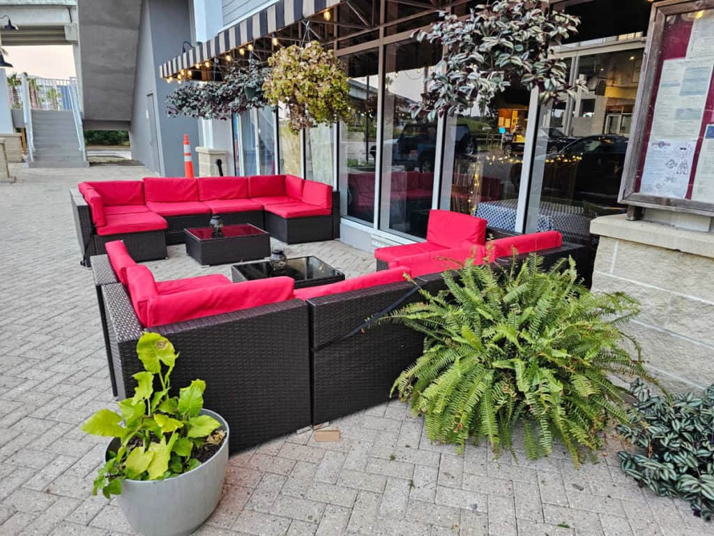 red outdoor couch outside of Ginny Lane bar and grill
