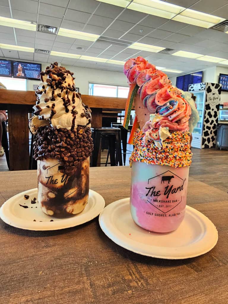 Two giant specialty milkshakes at The Yard covered in sprinkles and whipped cream