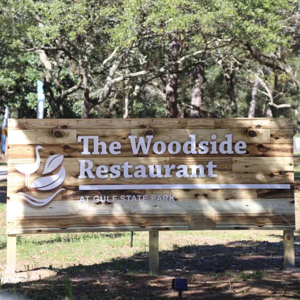 The Woodside Restaurant at Gulf State Park wooden sign