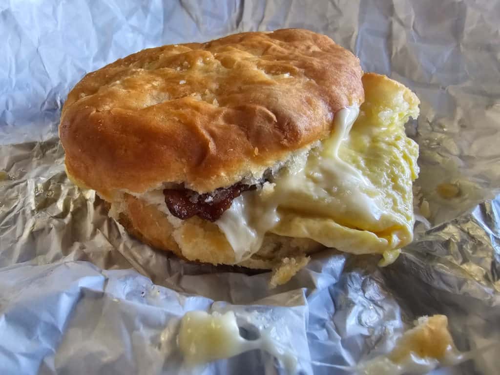 Bacon egg and cheese biscuit on a paper wrapper