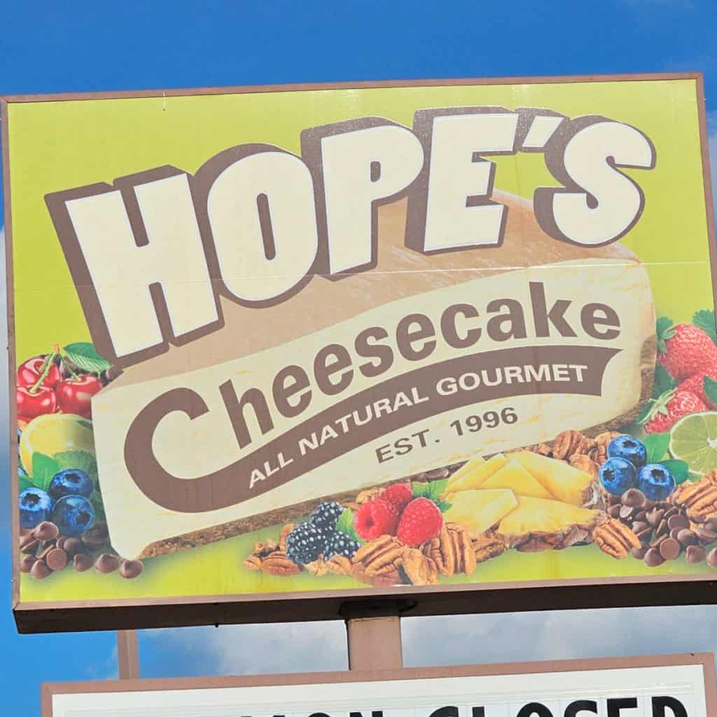 Hopes cheesecake sign with fruit and berries below the name
