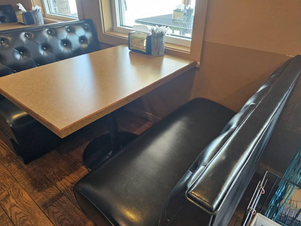 table with leather booth seats, Hope's cheesecake napkin dispenser
