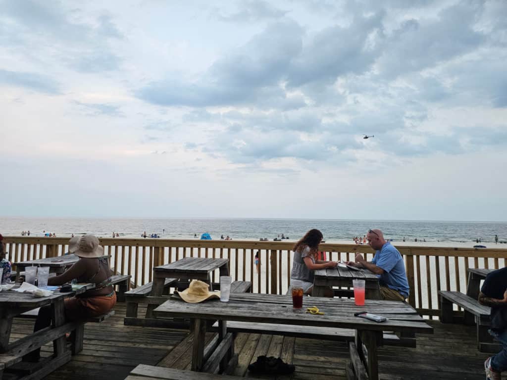 picnic tables on the deck of the Pink Pony Pub with views of the Gulf of Mexico