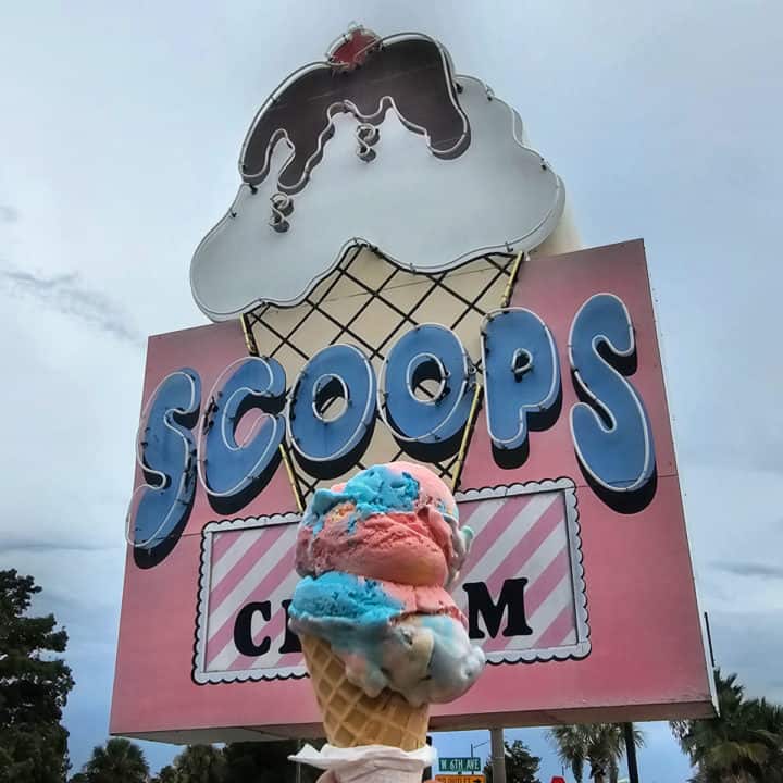 Ice cream cone in front of Scoops Ice Cream cone sign