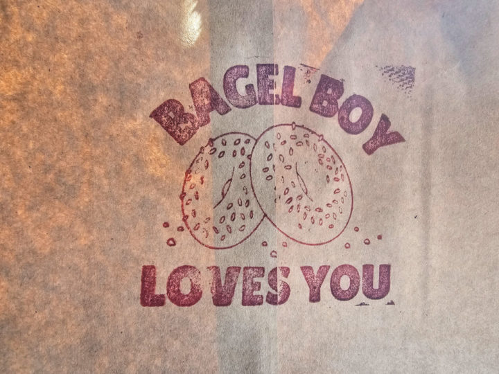 Bagel Boy Loves You text around two bagels on a bag. 