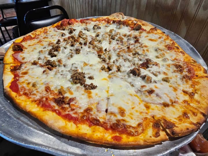 meat and cheese pizza on a pizza pan