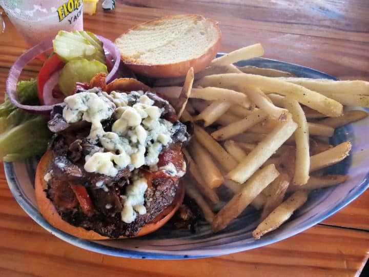 Build your own Bama Burger next to french fries and a cup of pickles