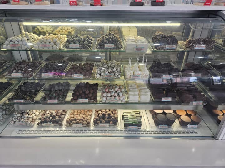 chocolate truffles and treats in a glass display case