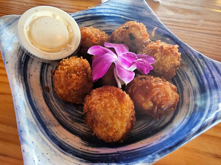 Crab and Parmesan Hush Puppies - Deep-fried hashbrowns, local blue crab and mashed potatoes folded with Parmesan and Créole seasoning served with chipotle bacon ranch.
