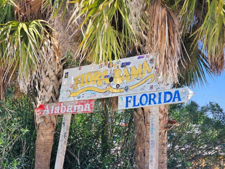 Flora Bama Alabama Florida Sign under a palm tree
