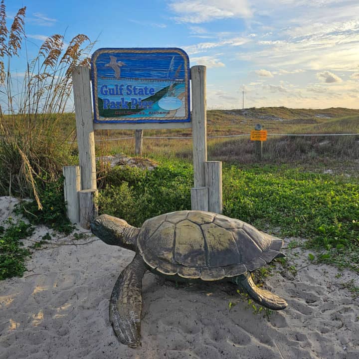 Gulf State Park Pier sign with turtle statue