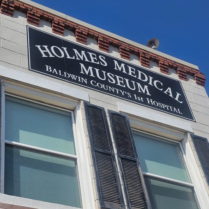 Holmes Medical Museum Sign on the outside of a brick building.
