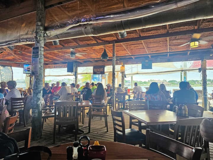 Indoor seating with tables and chairs at the Flora Bama Yacht Club