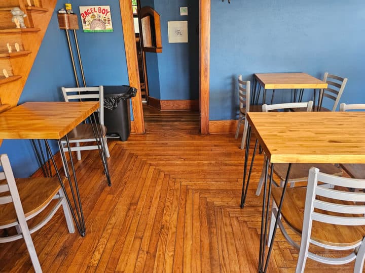 Indoor seating with tables and chairs at Bagel Boy Foley