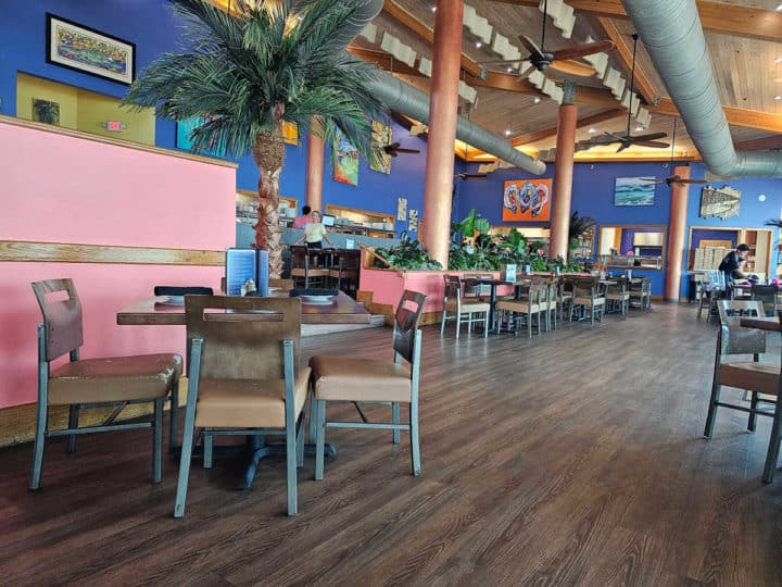 Indoor seating with tables and chairs at Cobalt Orange Beach