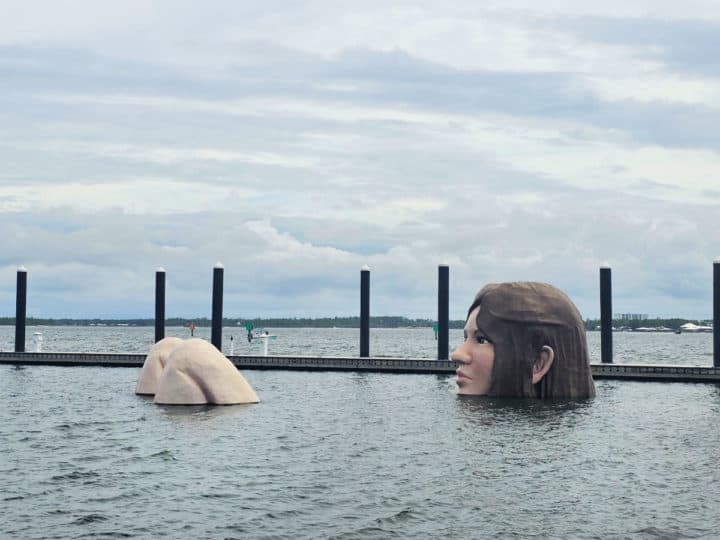 Lady in the Lake sculpture floating near a dock