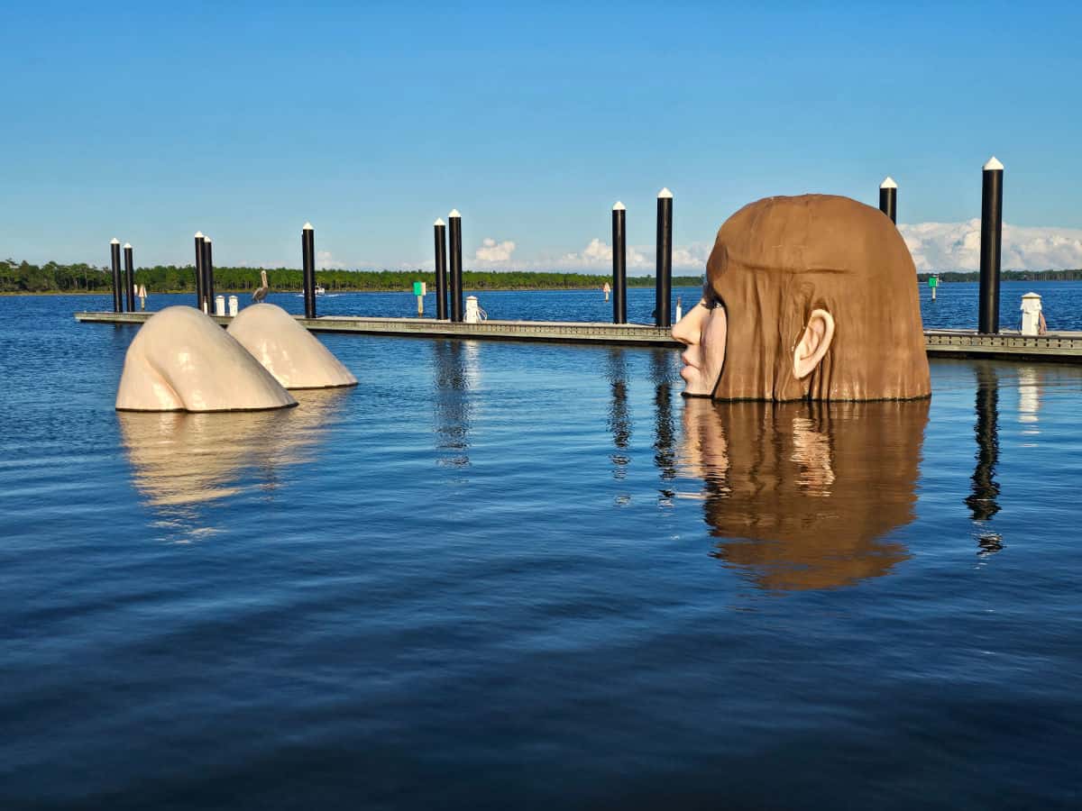 Lady in the Lake sculpture o a sunny day with a pelican on one of the knees