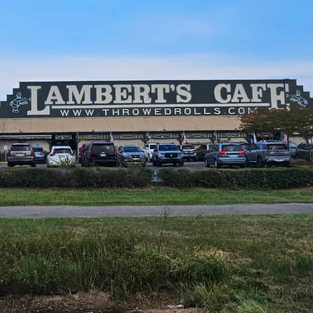 Lambert's Cafe Foley building with cars parked in front