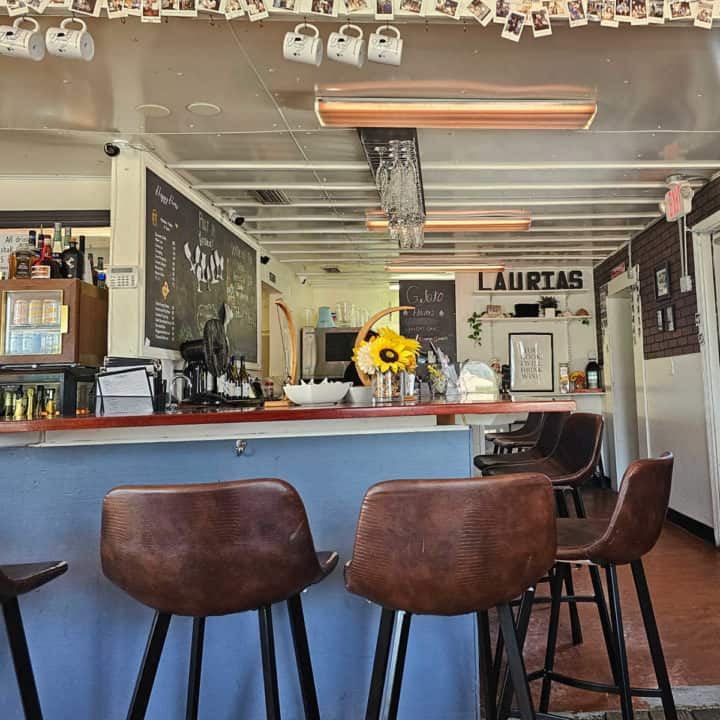 Interior of Lauria's by the Beach with bar stools and bar counter