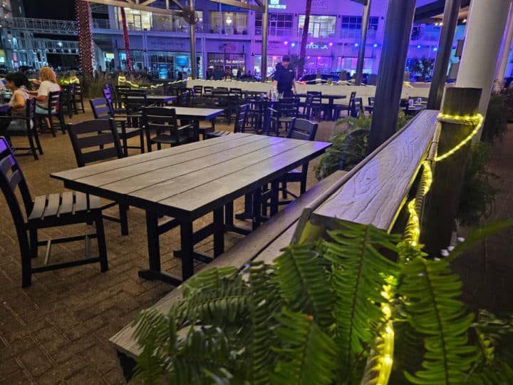 Outdoor seating with tables and benches at Villaggio Grille