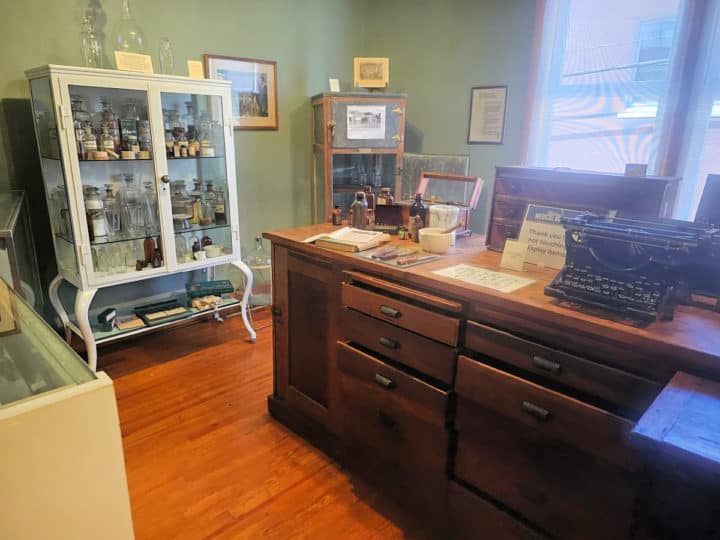 historic pharmacy room with equipment and display cabinet