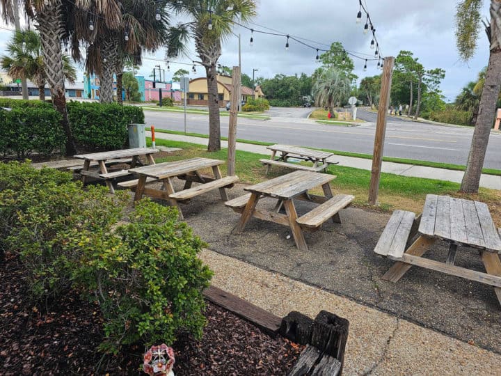 row of picnic tables near the road