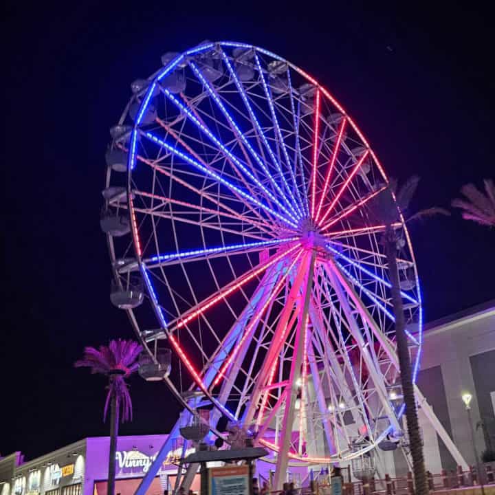 The Wharf Ferris Wheel list up red and blue at night