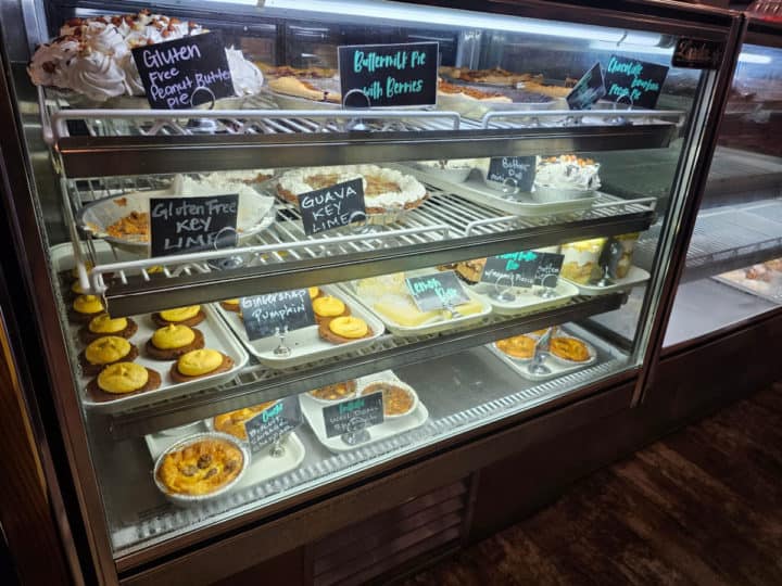 Bakery case with pies, quiches, and other baked goods